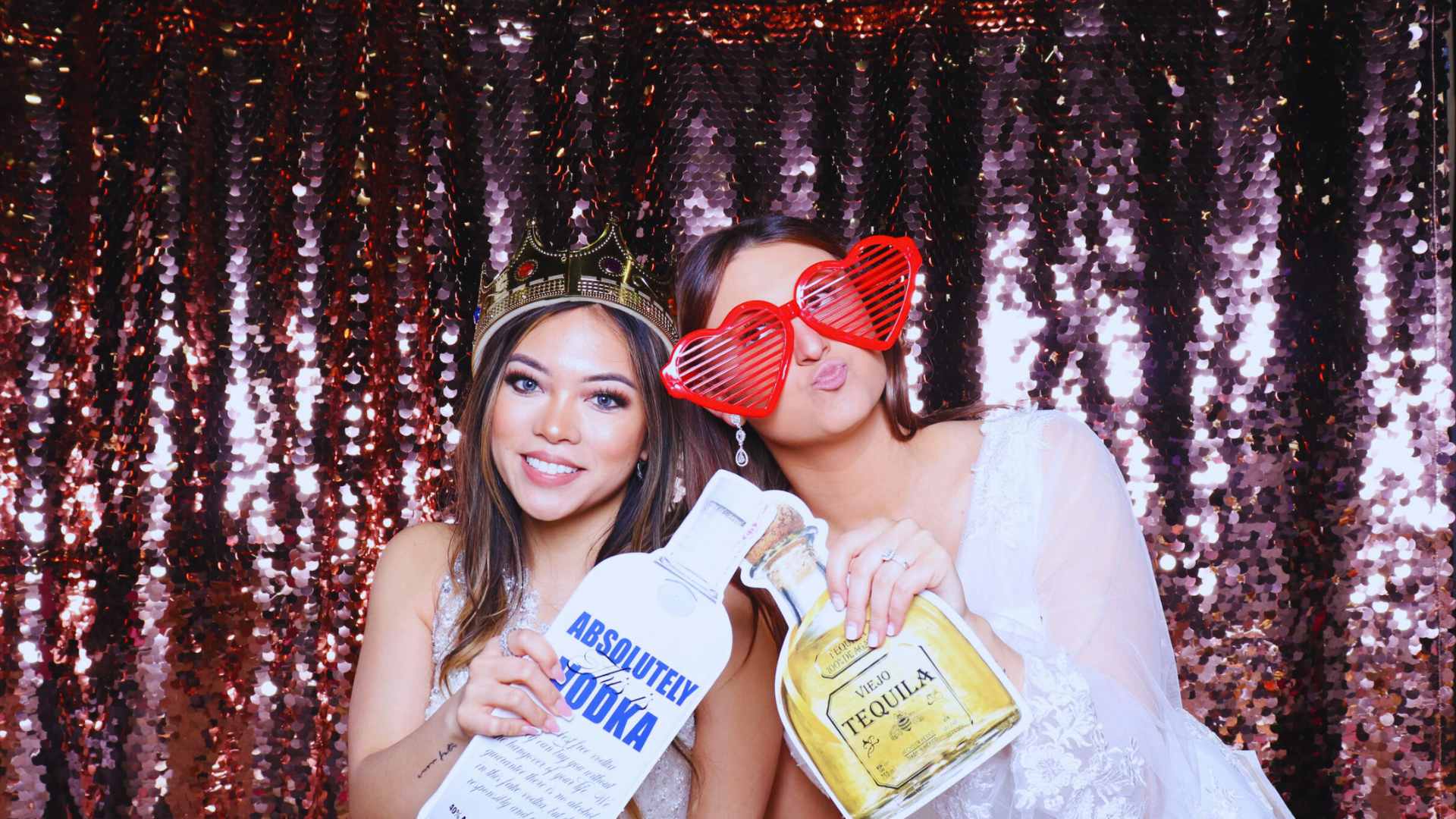 bride with friend in photo booth with props